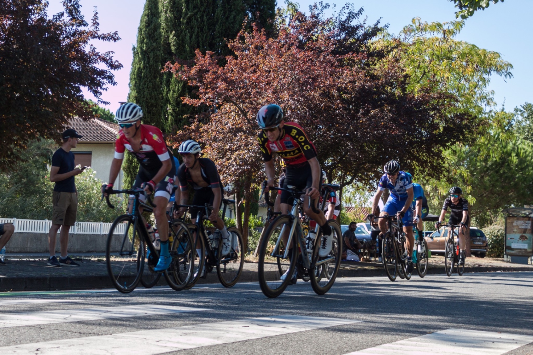 Coureur du BOC dans le peloton traversant un village lors d'une course